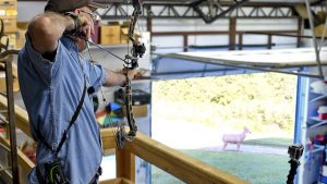 Grant practices with his bow from an elevated position.