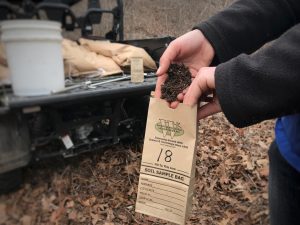 Putting soil into a bag for testing.