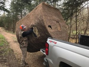 Tyler puts a Redneck Blind in the back of a pickup truck.