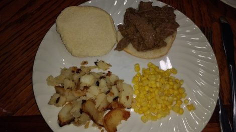 BBQ venison sandwich with potatoes and corn