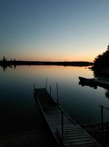 Sun glowing over water in Manitoba, Canada