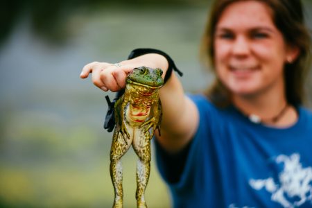 Raleigh holds a frog she got with her bow